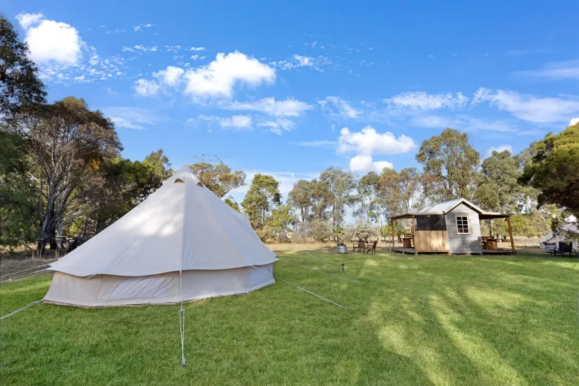 The Wanderlust glamping bell tent with its fire pit and camp kitchen