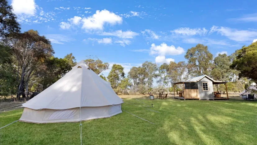 The Wanderlust glamping bell tent with its fire pit and camp kitchen