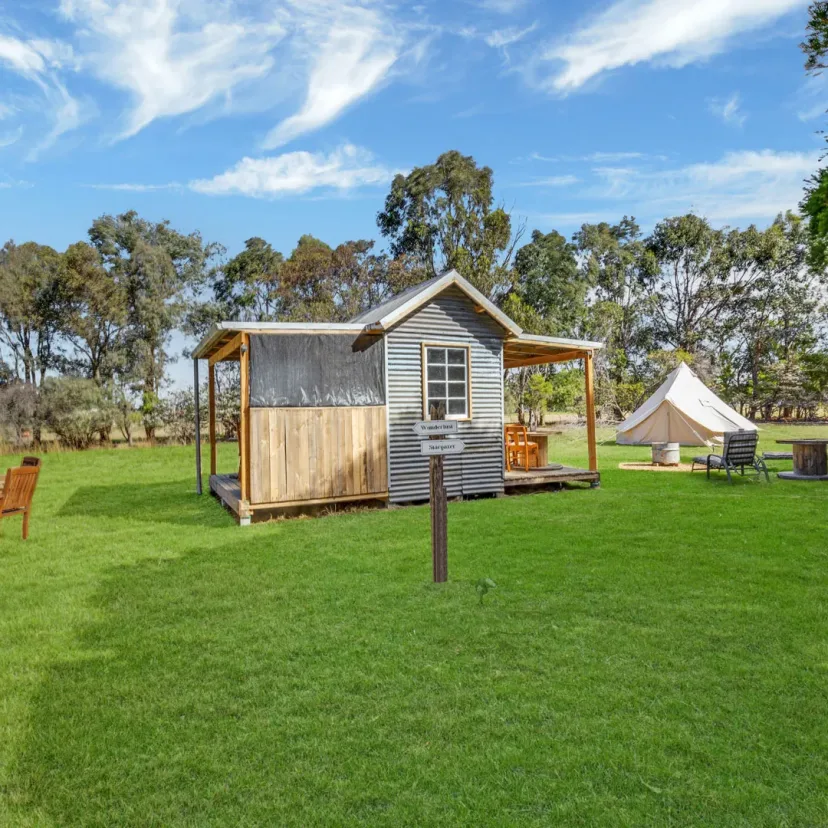 Interior and grounds at the Stargazer glamping tent, Eagle Point Cottages