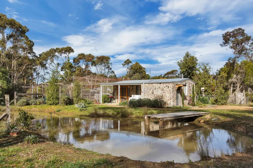 Shearers Cottage reflected in the property dam, with its little jetty