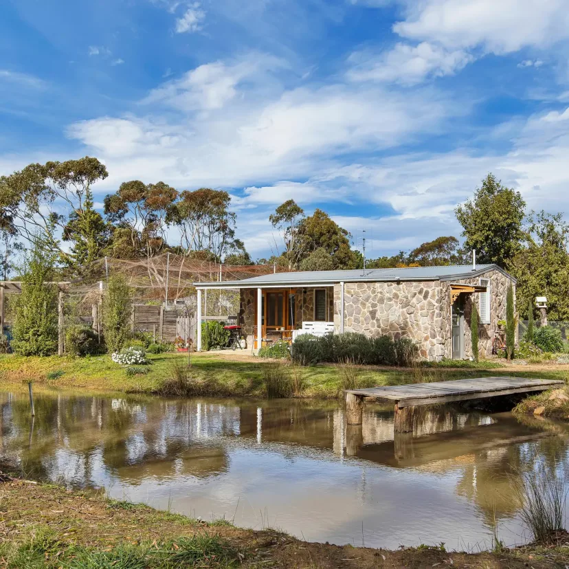 Shearers Cottage reflected in the property dam, with its little jetty