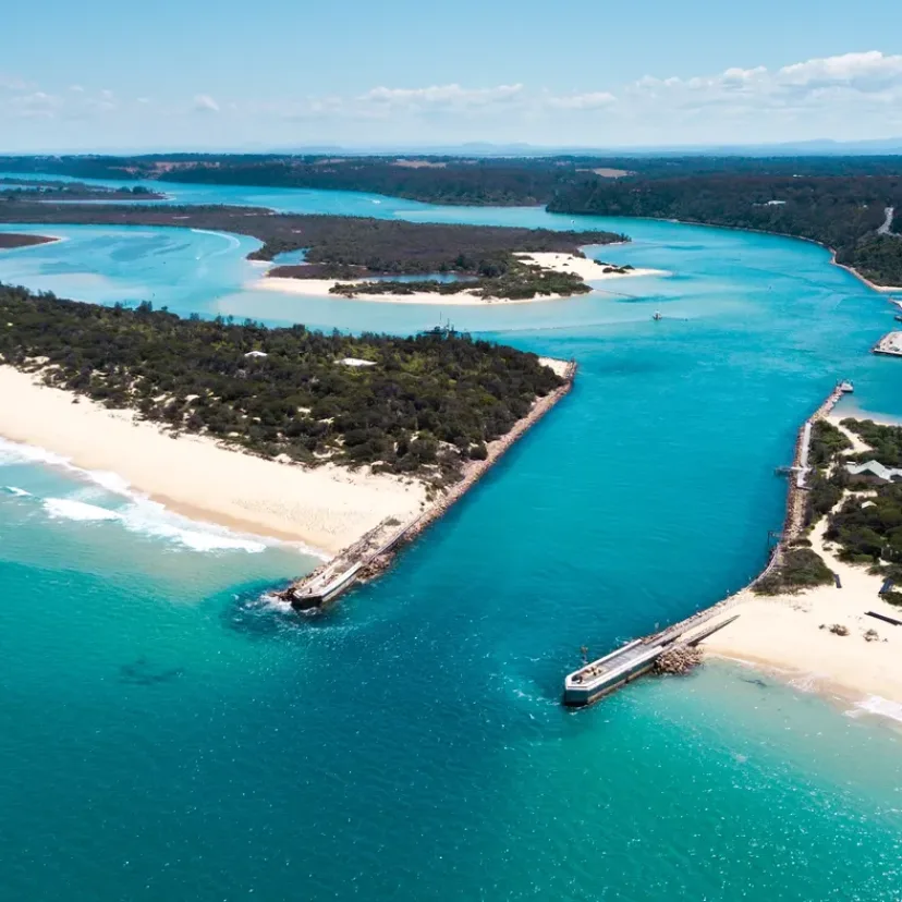 The entrance at Lakes Entrance from the air, with the sandbar and open sea beyond